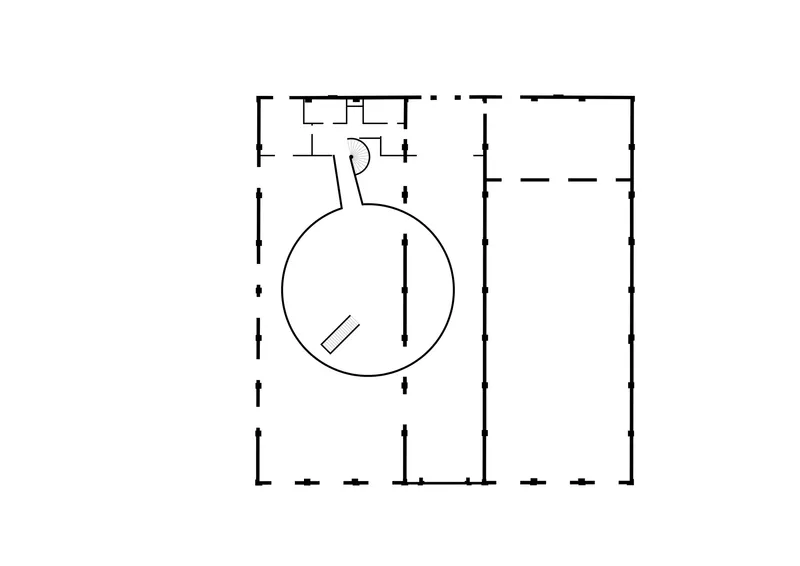 Floor plan drawing showing a circular volume connected to rectangular wings with service areas at the top