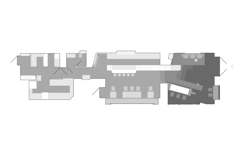 Floor plan drawing showing an elongated interior with central service core and angled corner volume