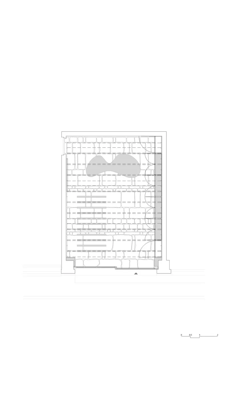 Floor plan drawing showing a rectangular layout with a curved central void and modular seating arrangement