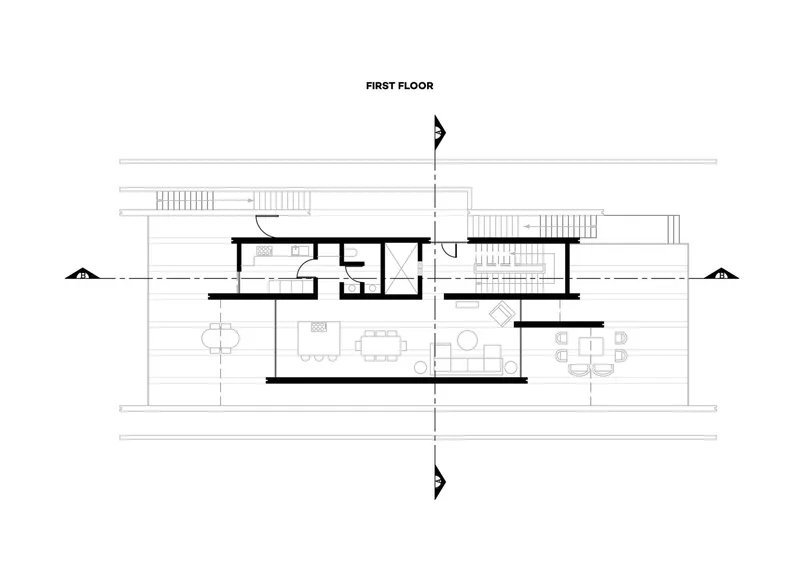 First floor plan showing living and dining spaces flanked by exterior decks and staircases