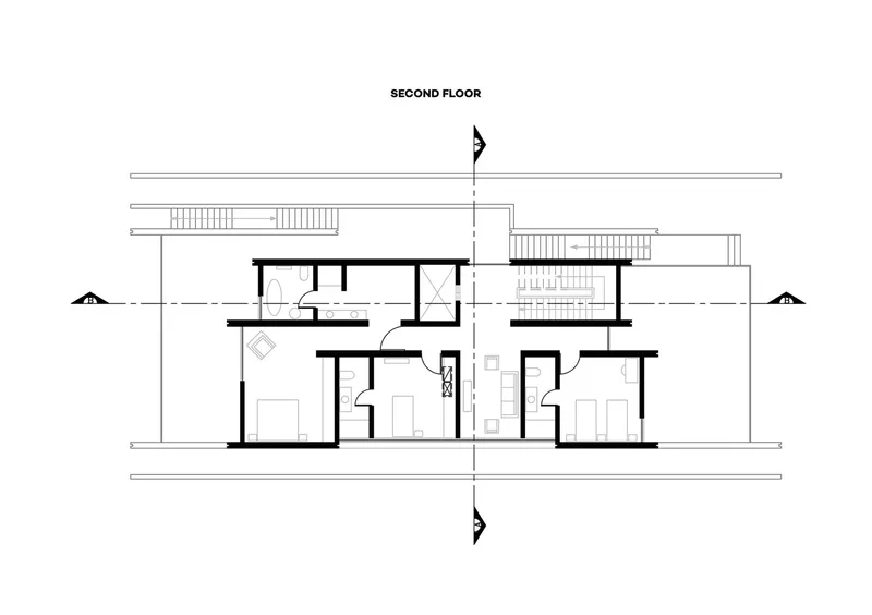 Second floor plan showing two bedroom suites separated by a central stairwell