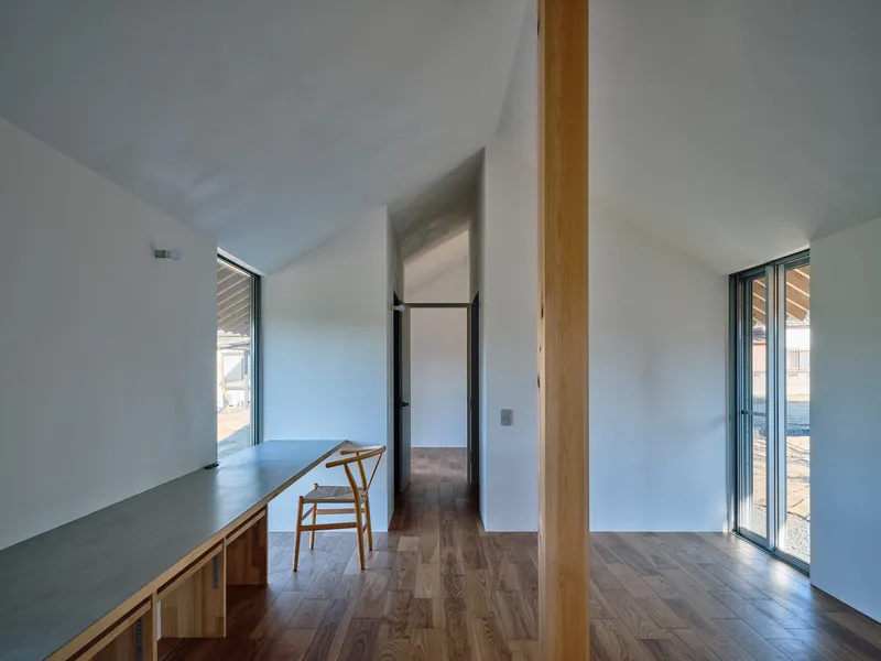 Interior hallway view with single timber column framing passage to adjacent rooms under vaulted ceiling
