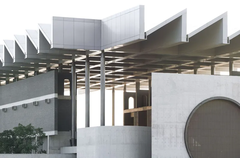 Architectural model showing coffered canopy structure and intersecting concrete volumes with circular and arched openings