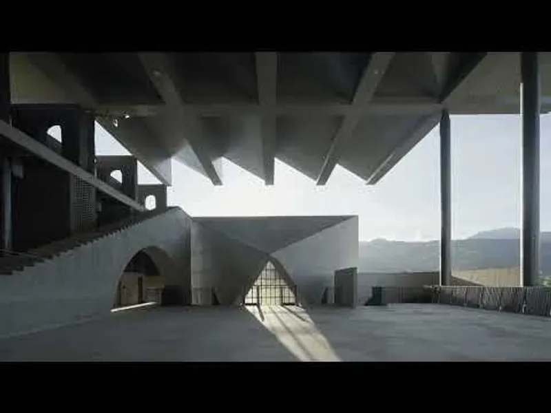 Upper terrace beneath the coffered concrete canopy with arched openings and distant mountains