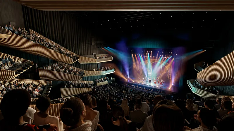 Interior view of the tiered balconies with vertical slat cladding during a performance under stage lights
