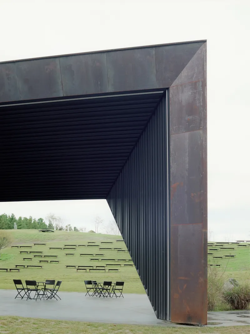 Detail of the weathered steel frame meeting the ribbed soffit above the concrete terrace