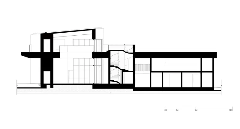 Section drawing revealing a multi-level interior with a spiral staircase connecting the spaces