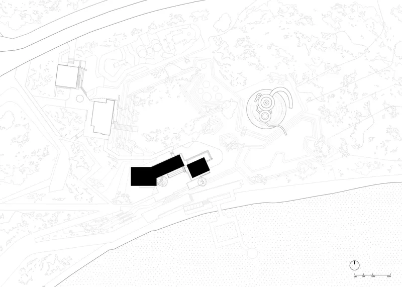 Site plan drawing showing two angular buildings in solid black positioned within a landscape with topographic contours