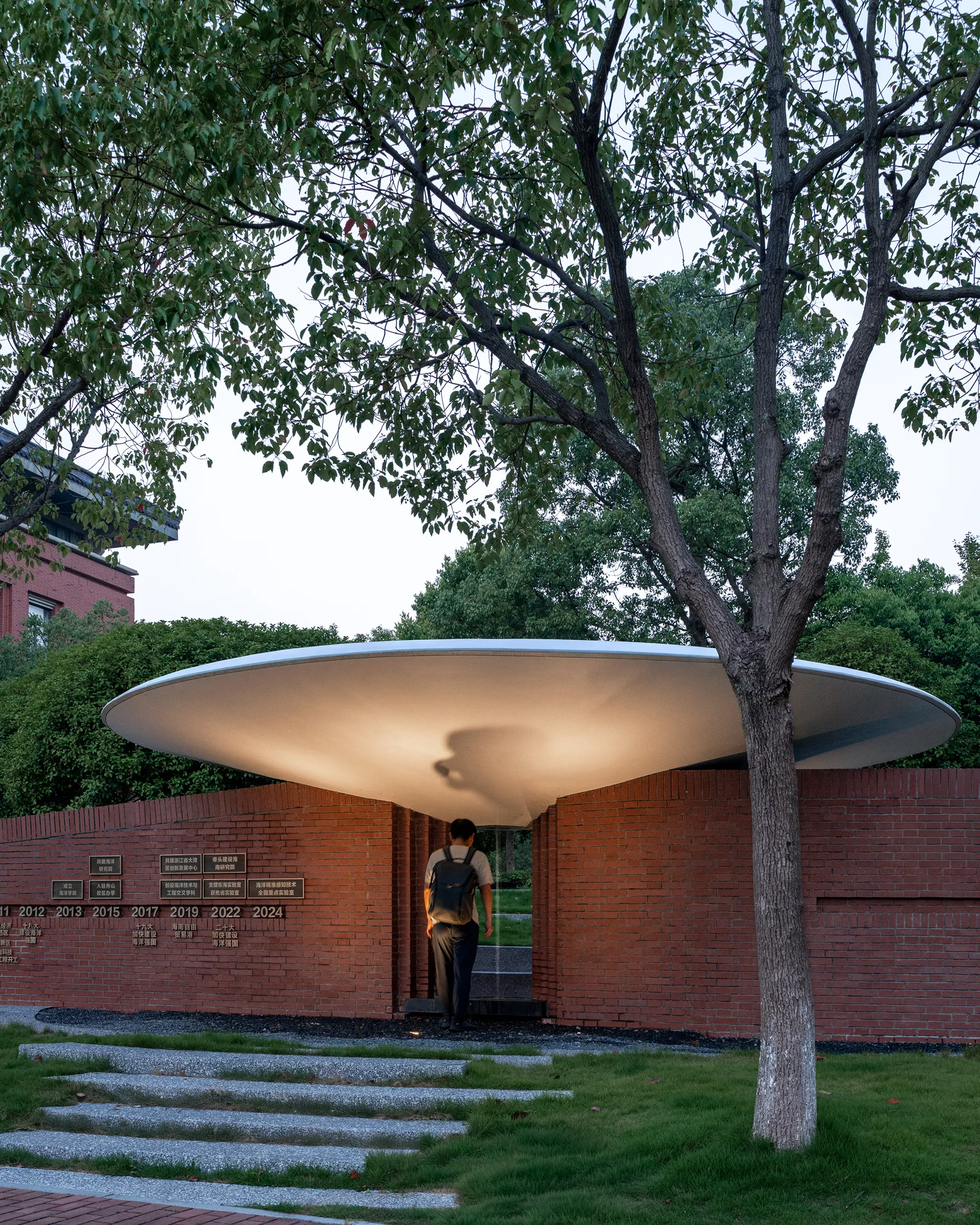 UAD Floats a Concrete Disc Over a Brick Pavilion on Zhejiang University's Island Campus
