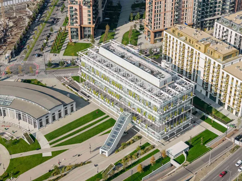 Aerial view of the white steel-framed greenhouse structure surrounded by lawns and residential towers