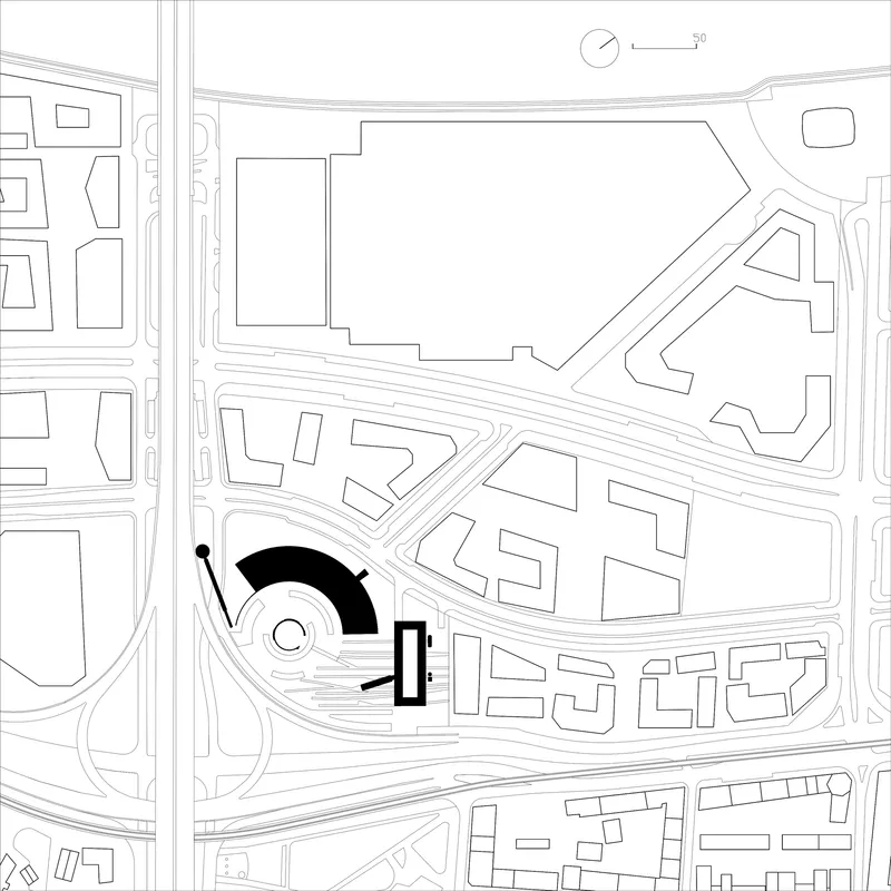 Site plan drawing showing a circular structure and rectangular volume within an urban street grid