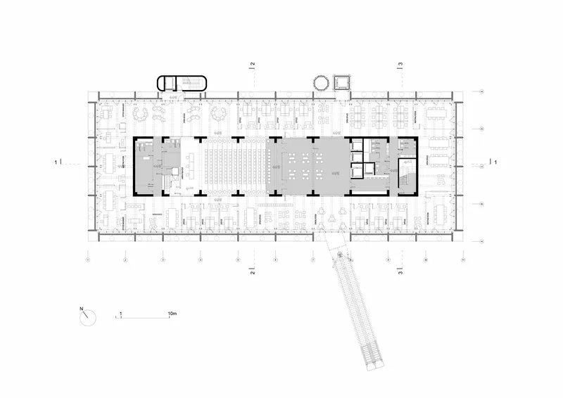 Floor plan drawing showing an open layout with central seating areas and enclosed service cores