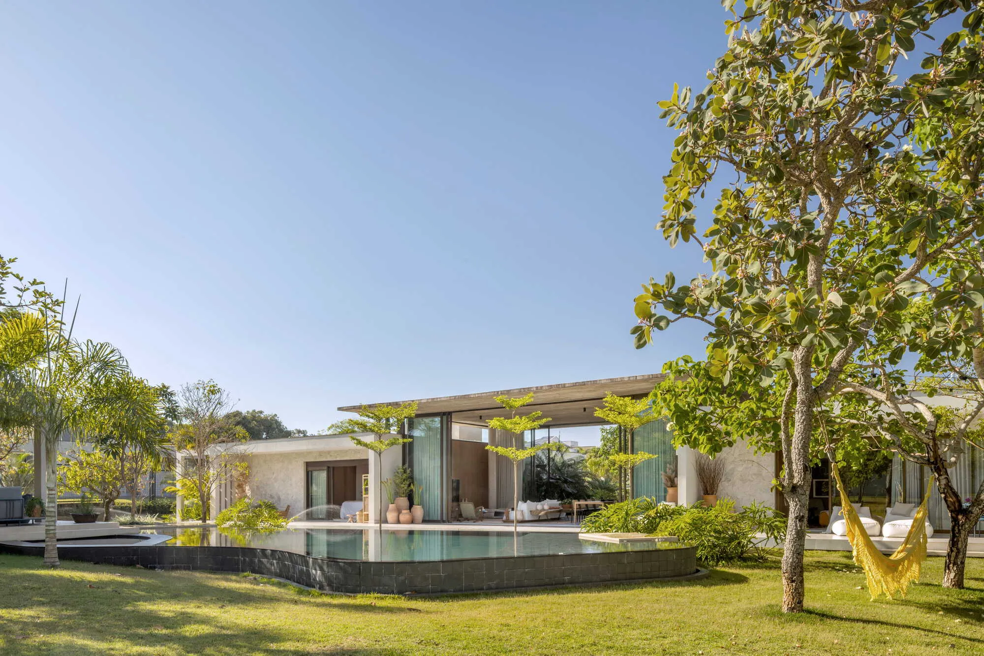 Studio Gontijo Splits a Brasília House into Two Wings Joined by a Glass Pavilion