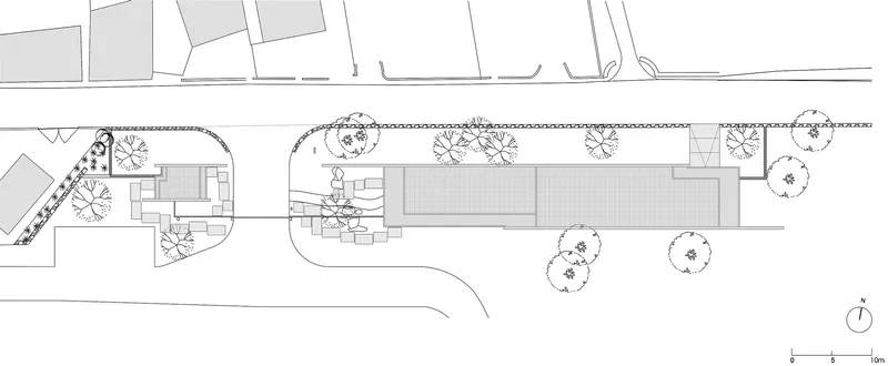 Roof plan drawing illustrating the structure's elongated form with surrounding vegetation and site context