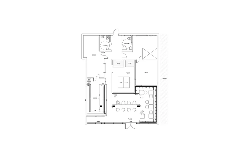 Floor plan drawing showing the layout of restrooms, kitchen, storage, and seating areas