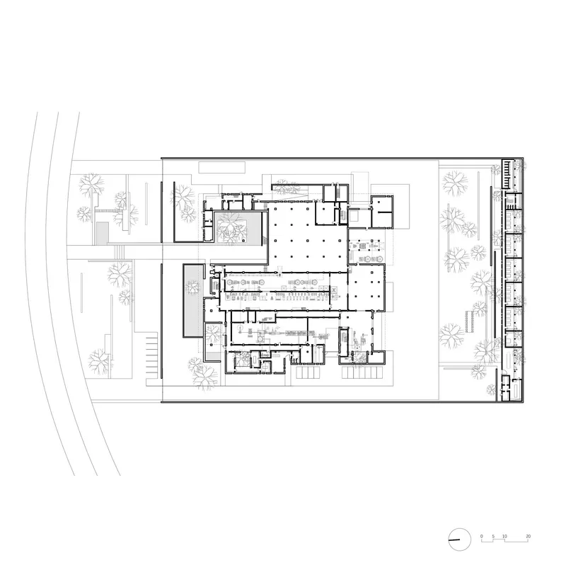 Ground floor plan drawing showing the arrangement of rooms around a large central hall with grid columns