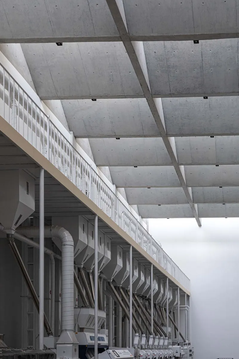 Detail of the coffered concrete ceiling and continuous clerestory windows above the industrial equipment