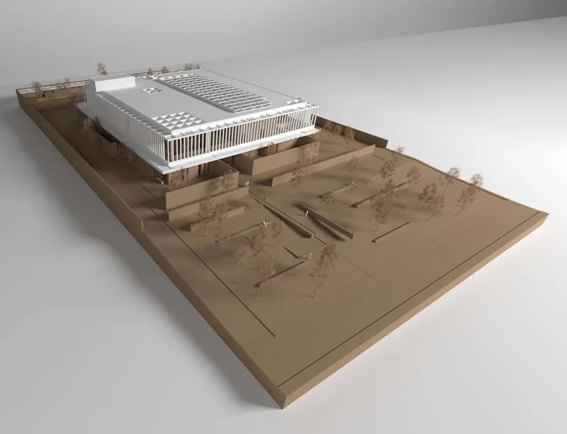 Physical model showing the white rectangular volume elevated above a terraced plaza with landscaped courtyards