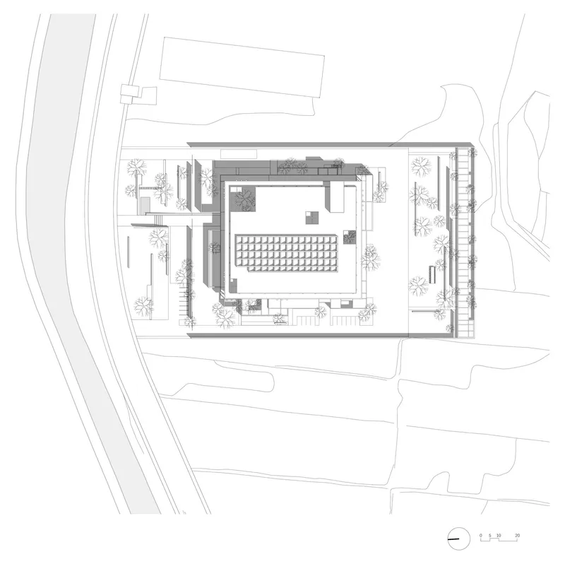 Site plan drawing showing the rectangular building with central courtyard surrounded by planted terraces and pathways