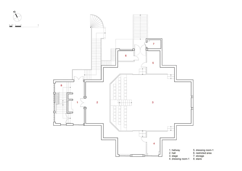 Floor plan drawing showing a central stage area with seating rows and adjacent dressing and storage rooms