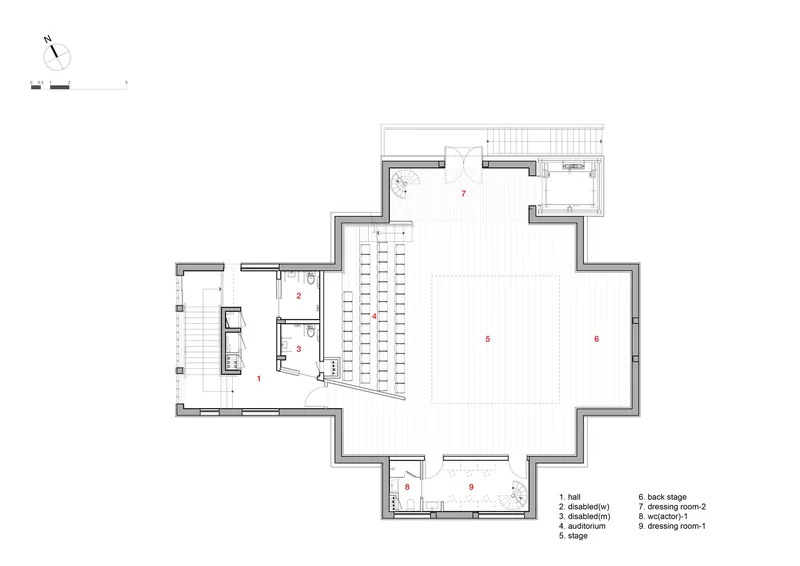 Floor plan showing an auditorium with seating rows and adjacent accessible facilities with circulation stair