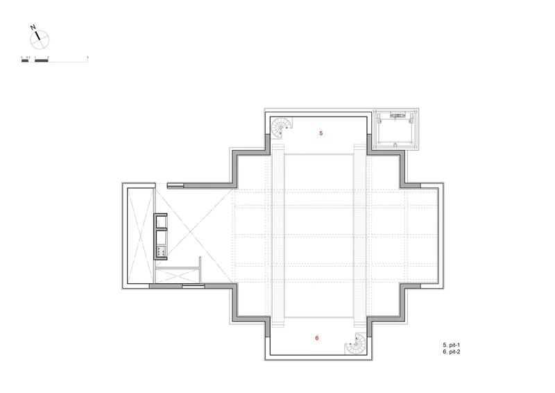 Floor plan showing open performance space with flanking circulation zones and adjacent lift core