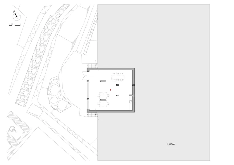 Site plan showing office layout with workstations within a rectangular footprint near landscaped edges