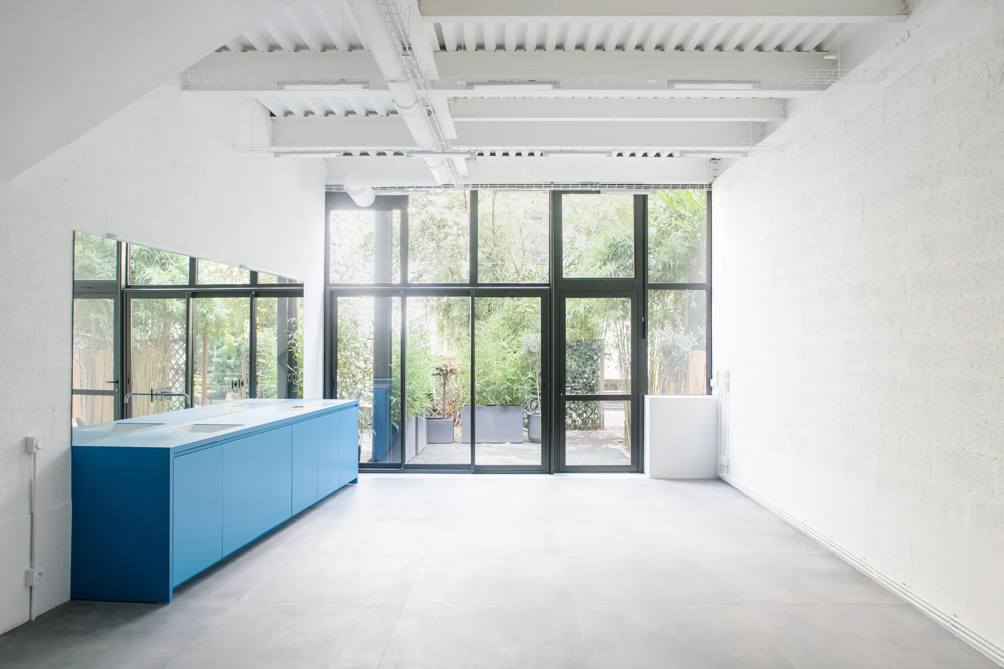 miogui Converts a Montreuil Commercial Unit into a Layered Glass-and-Steel Loft