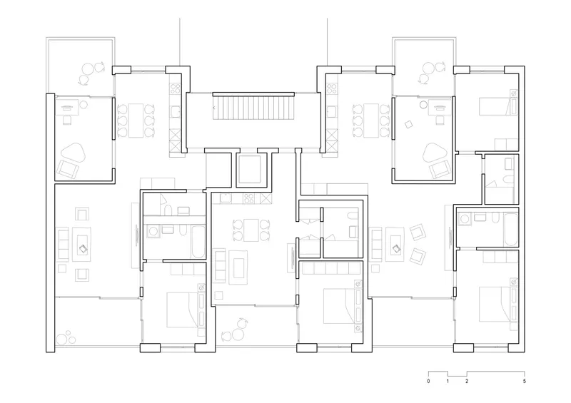 Floor plan drawing showing four residential units clustered around a central stairwell