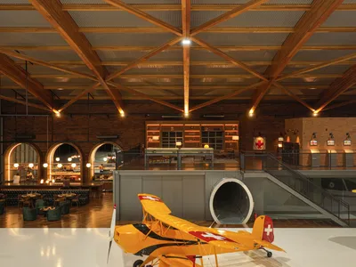 Nola Arquitetura Builds Brazil's Largest Laminated Wood Arch to Shelter Vintage Aircraft