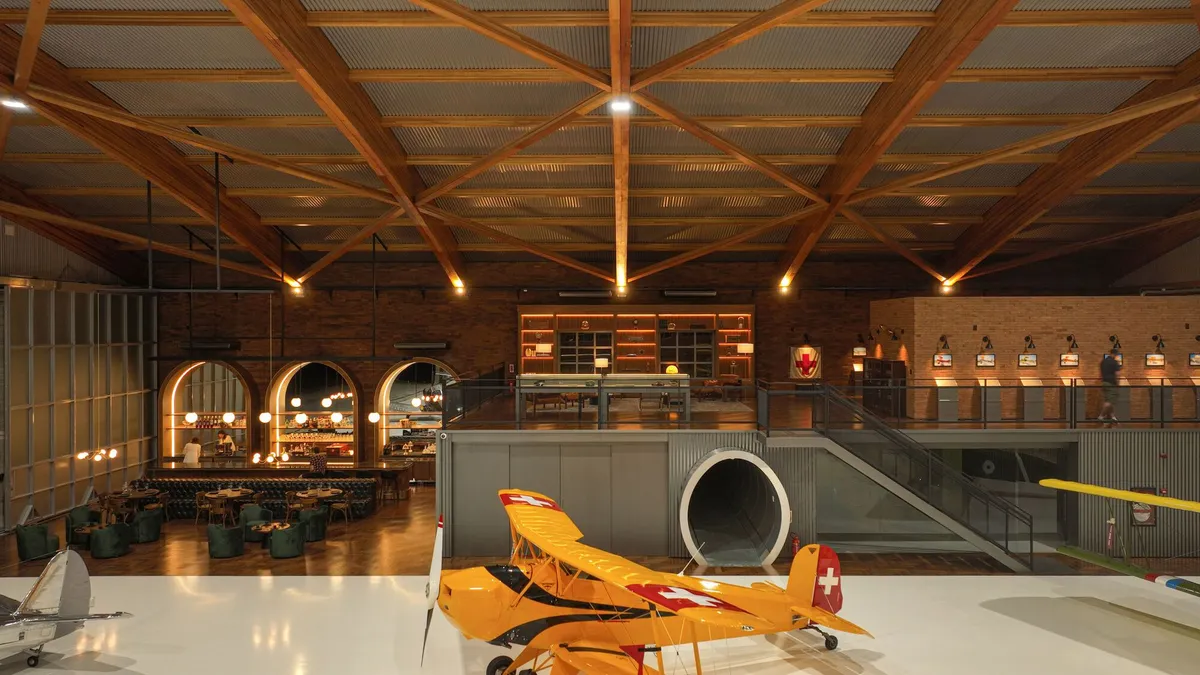 Nola Arquitetura Builds Brazil's Largest Laminated Wood Arch to Shelter Vintage Aircraft