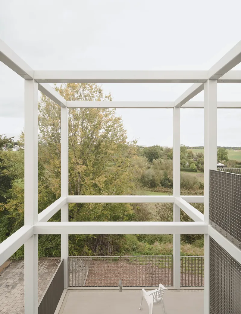 White steel frame pergola on balcony overlooking rolling farmland and trees in autumn foliage