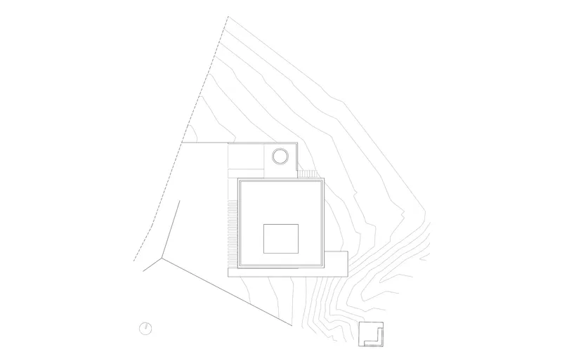 Site plan drawing showing the rectilinear building volume set within sloping topographic contour lines