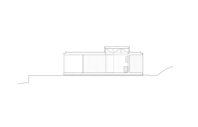 Elevation drawing showing the low-slung horizontal profile with clerestory monitor and ladder access to rooftop