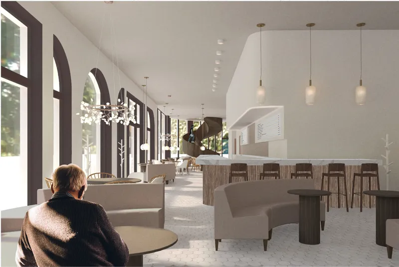 Main seating area with arched windows, soft daylight, and a central coffee bar defining the cafe’s warm social atmosphere.
