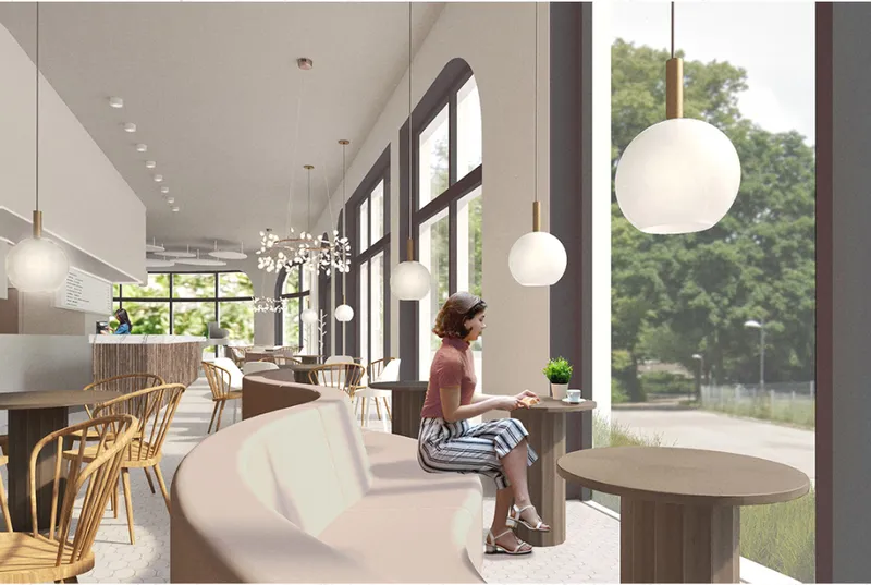 Window-side seating frames greenery outside, offering a calm spot for coffee, work, and quiet conversation.