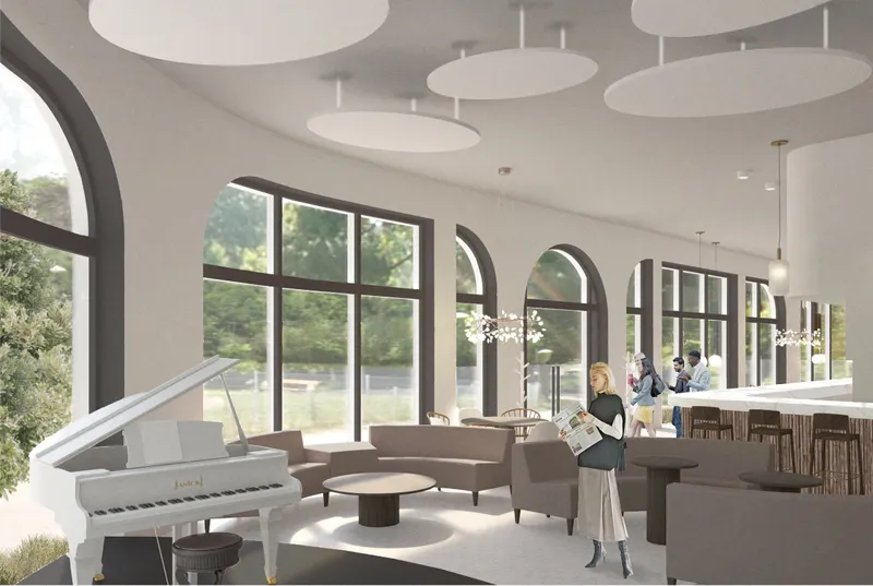 Bright performance lounge with arched glazing, soft seating, and a piano anchoring the cafe’s cultural identity.