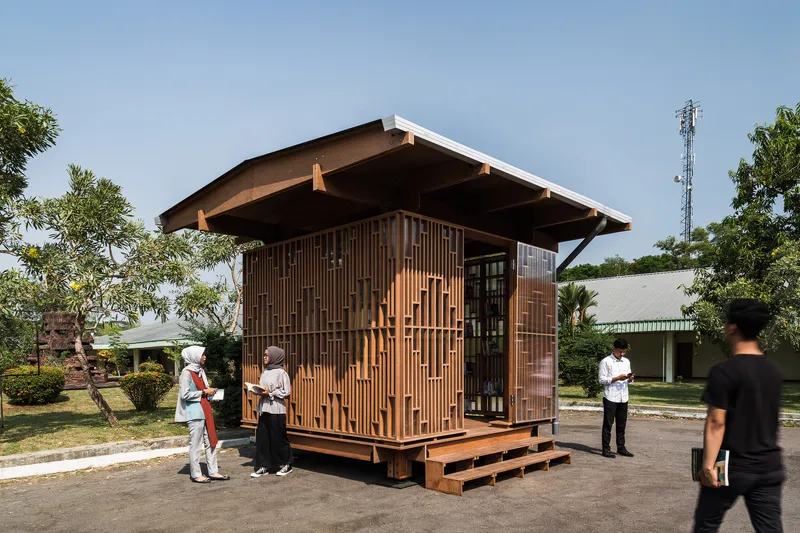 Timber pavilion with slatted screen walls and cantilevered roof on a platform with visitors in daylight