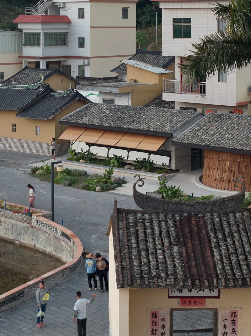 Elevated view of the courtyard with curved planted beds surrounded by grey tiled roofs