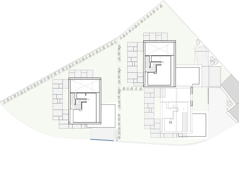 Site plan drawing showing two residential buildings with central access road and tree symbols