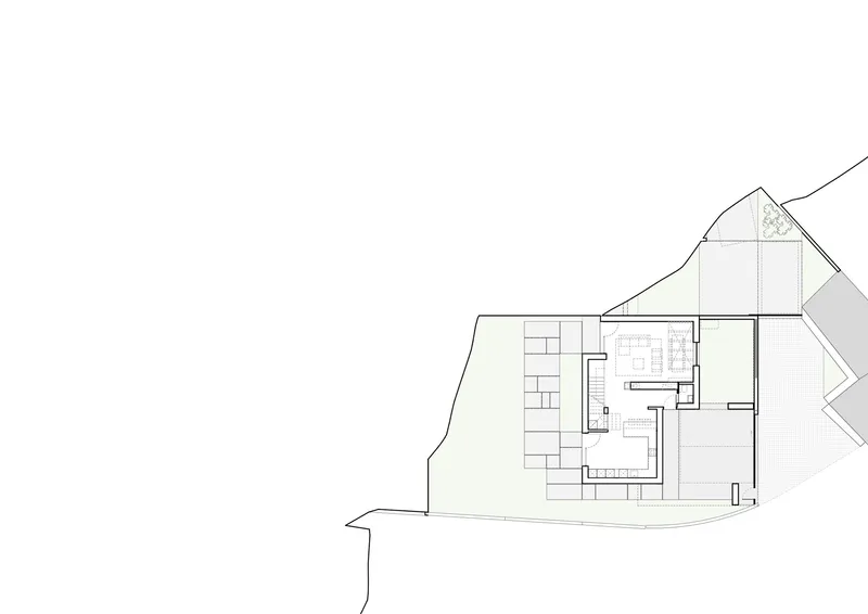 Site plan drawing showing single building footprint with pitched roof outline on sloped terrain