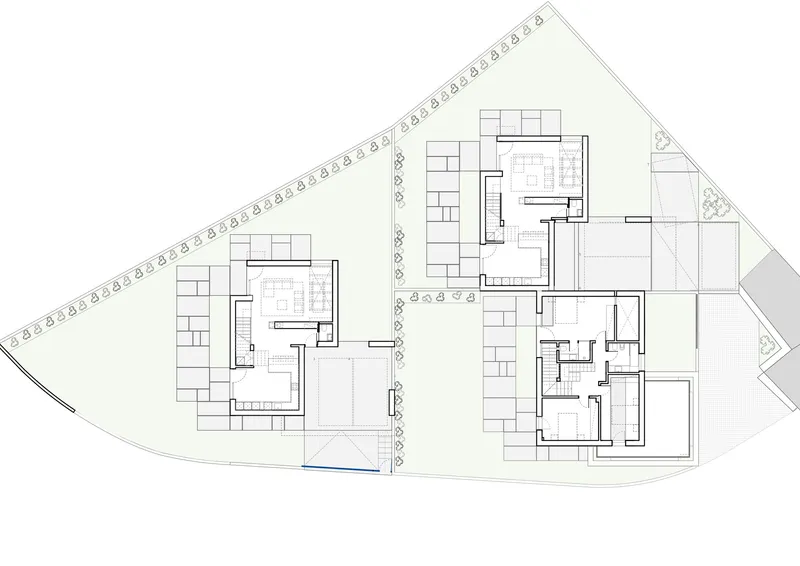 Site plan drawing showing two residential buildings with courtyards on a sloping trapezoidal lot