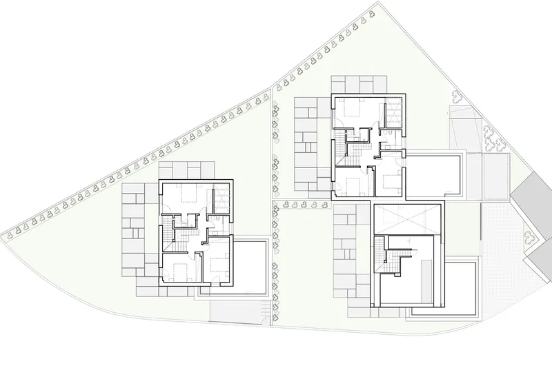 Floor plan drawing showing two residential units with central staircases and surrounding landscaping