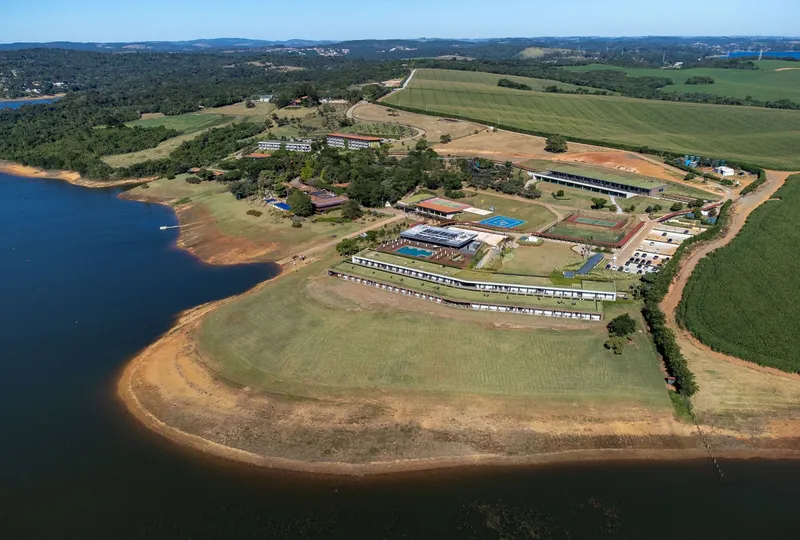 Wide aerial view of the entire resort complex on a peninsula extending into the reservoir
