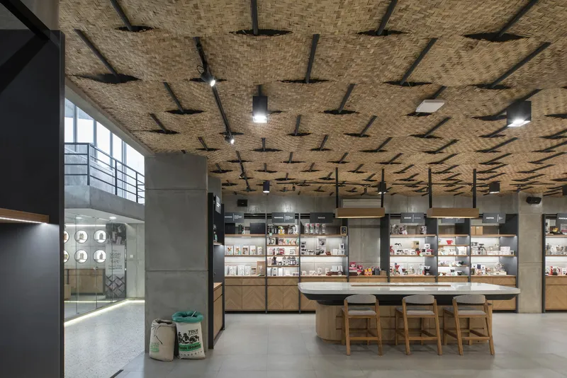Interior view of the undulating bamboo ceiling above product shelving and seating area