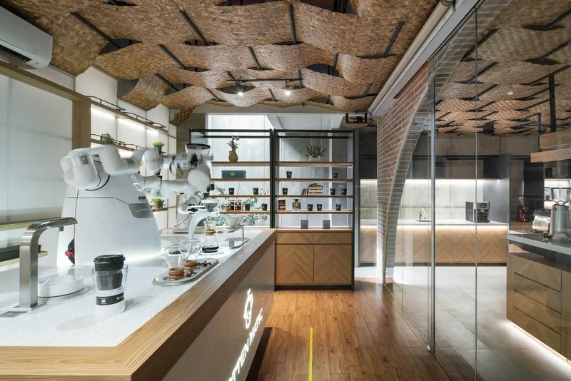 Interior view of coffee counter with woven bamboo ceiling panels and glass partition separating service areas