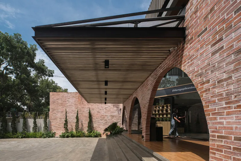 Underside of the timber slatted canopy with steel beams over the entrance courtyard