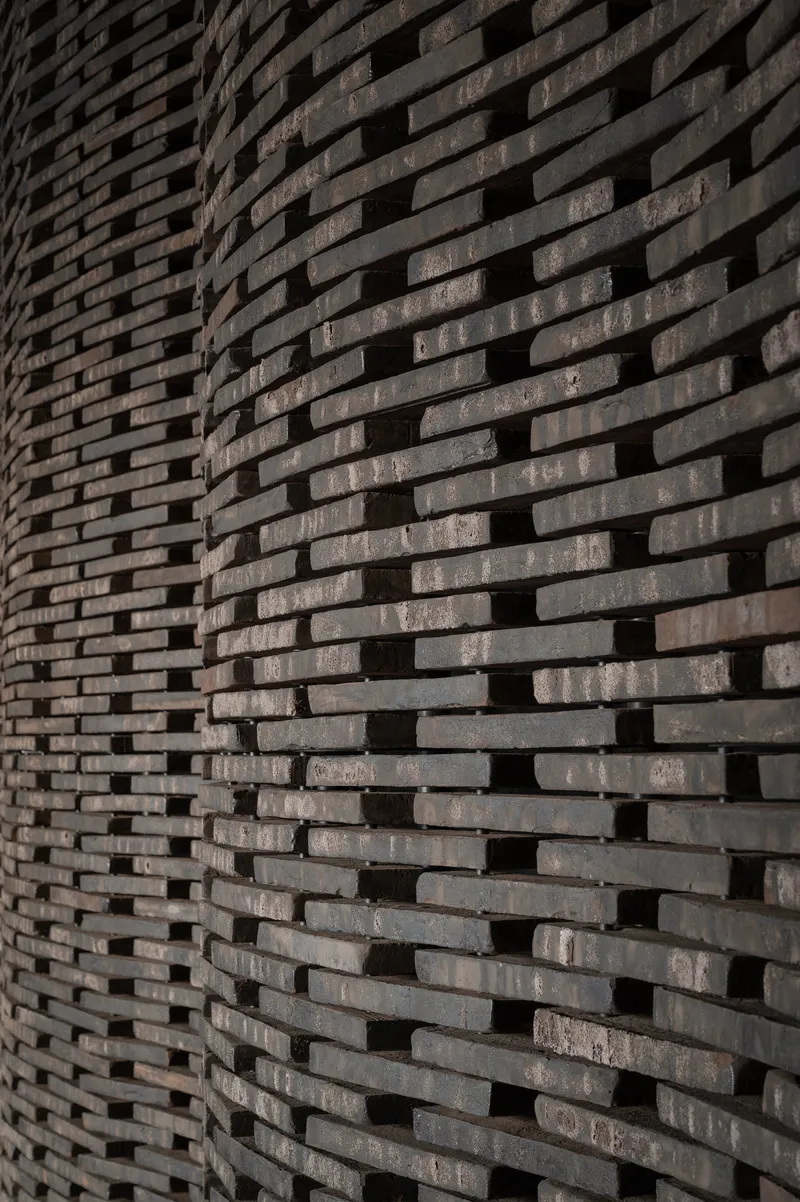 Close-up of textured brick wall with staggered courses creating a rhythmic pattern
