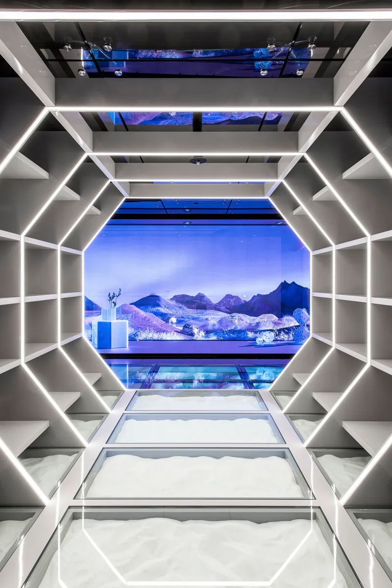LED-edged octagonal passageway framing a blue projected mountain landscape at its terminus