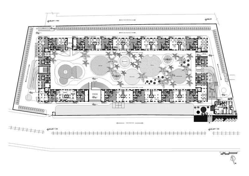 Site plan drawing showing residential units framing a central landscaped courtyard with circular water features and planted beds